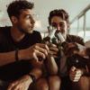 Photo of three male students playing a drinking game.