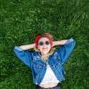 Photo of a girl laying on a bed of lush grass.