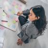 Photo of a person sitting down with sticky notes to set goals for the year.