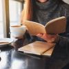 Photo of a student studying at a cafe with a latte.