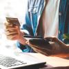Person holding a phone and credit card