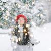 Photo of a student throwing snow into the air surrounded by twinkle lights.