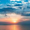 Photo overlooking an expanse of ocean at sunset.