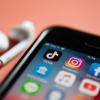 iPhone screen with social media app icons like TikTok, Instagram and Facebook