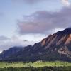 Photo of the flatirons at sunset with a foggy overcast.