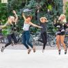 Photo of roommates jumping in the air together on campus.