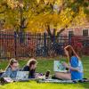 Photo of a group of students studying for class on Farrand Field in the fall.