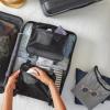 Person packing a suitcase