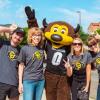 Group photo of staff members posing with Chip. 