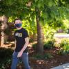 Two students in masks walking on campus.