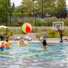 Photo of students hitting a large beach ball around the buff pool.