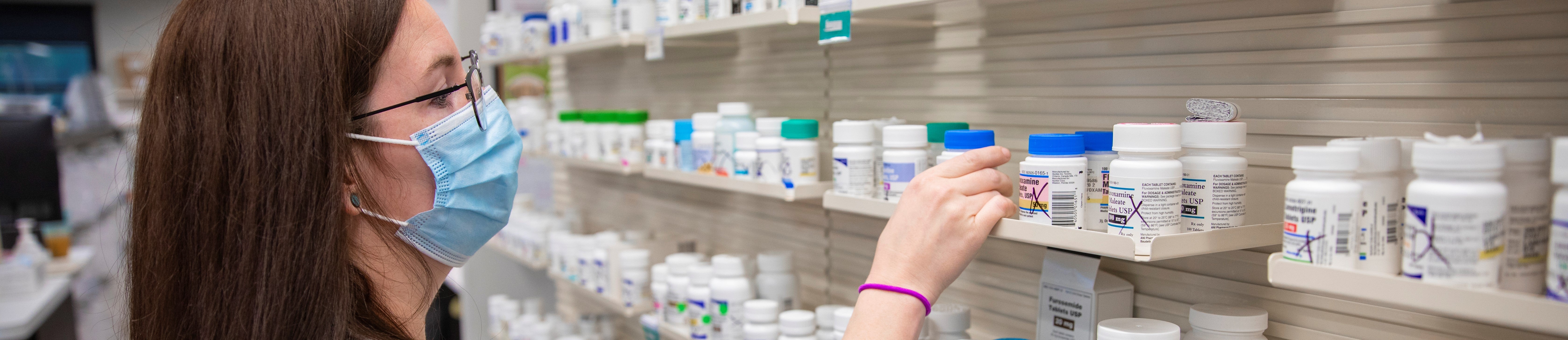 a pharmacist choosing pills