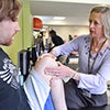 Physical therapist checking patient's knee