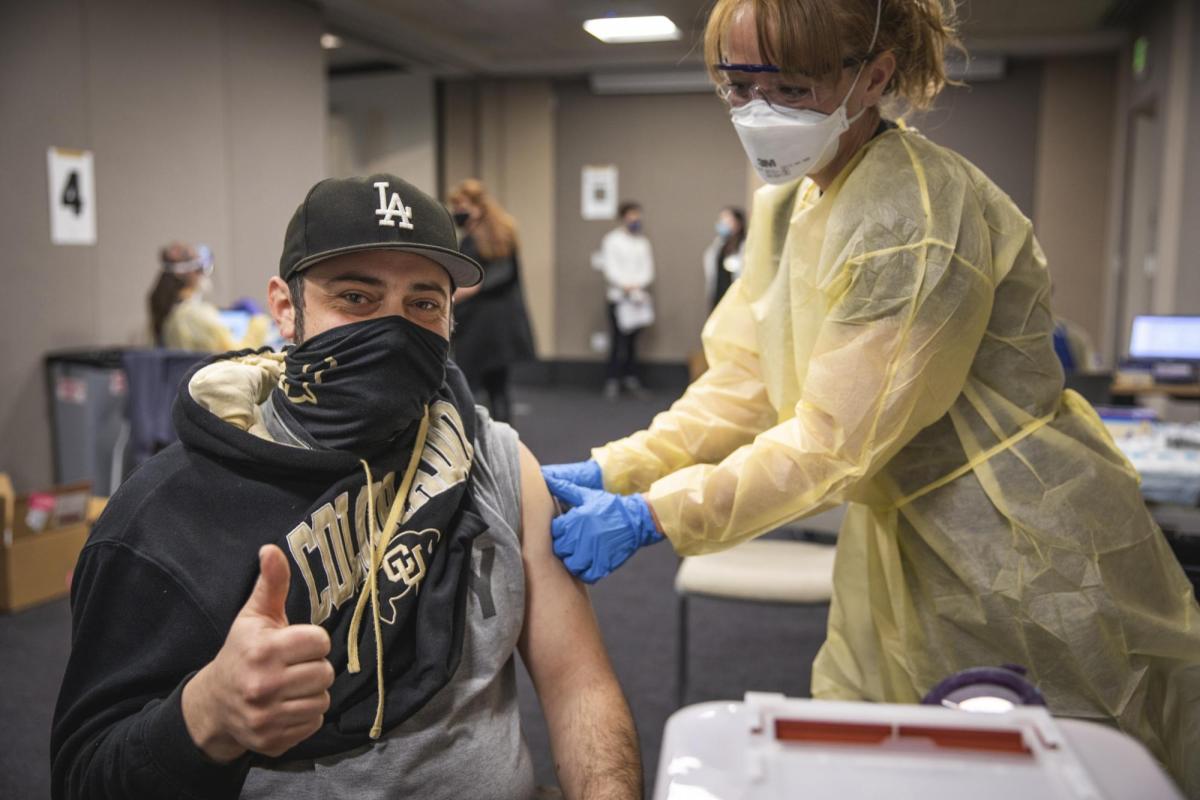 man in cu gear giving a thumbs up as he gets a shot
