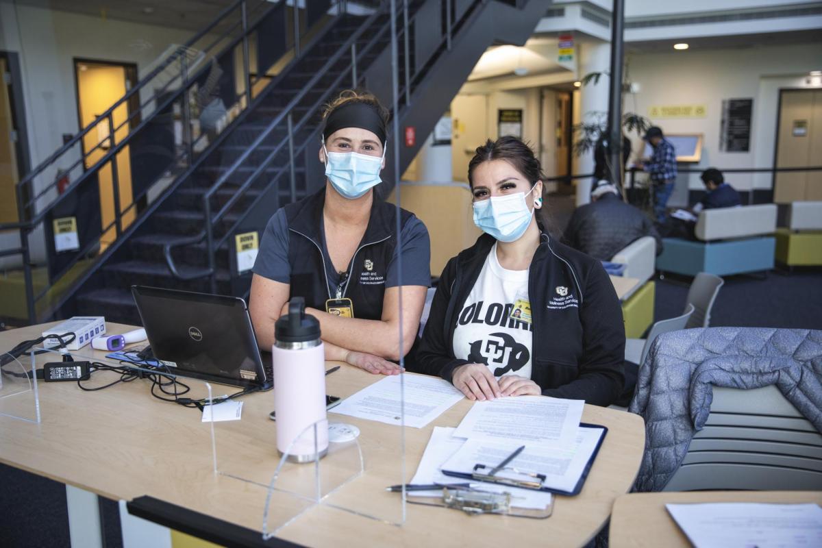 women at the desk of the vaccine center