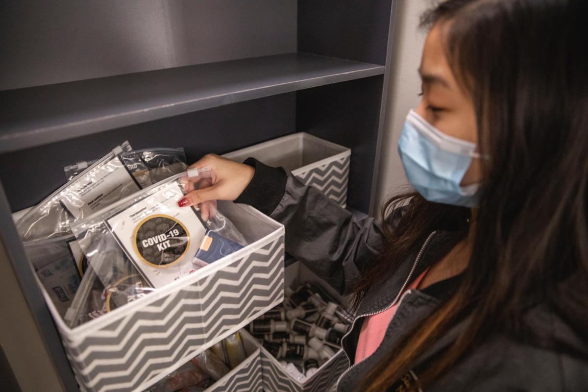Photo of a student picking up free cold care supplies in the Wellness Suite.
