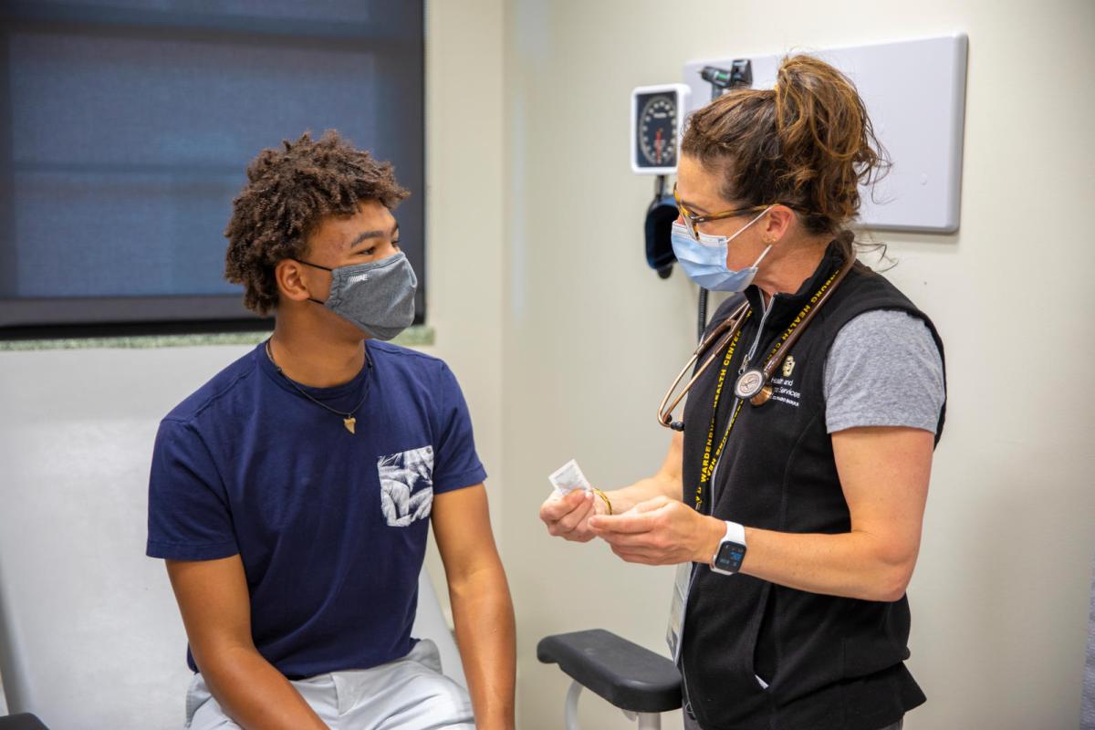 Photo of a student meeting with a physician. 