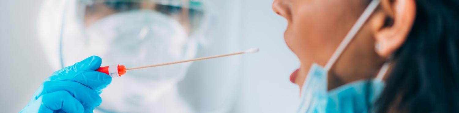 woman about to be swabbed by a medical professional