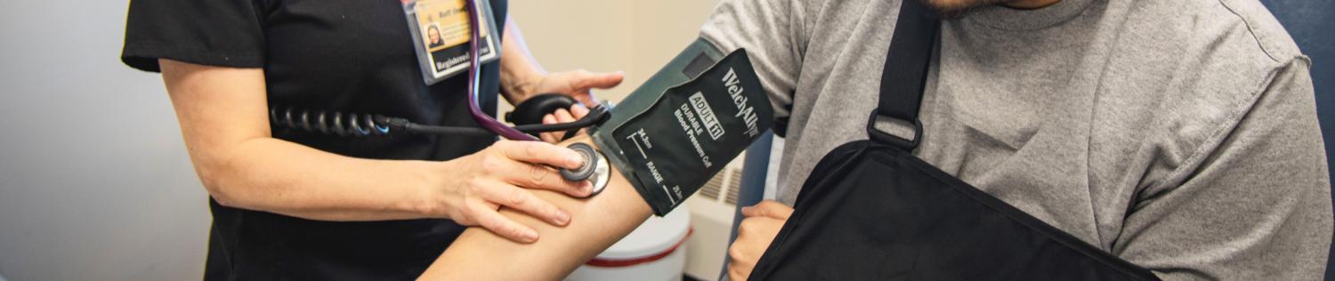 a CU Boulder doctor checking blood pressure