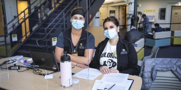 women at the desk of the vaccine center