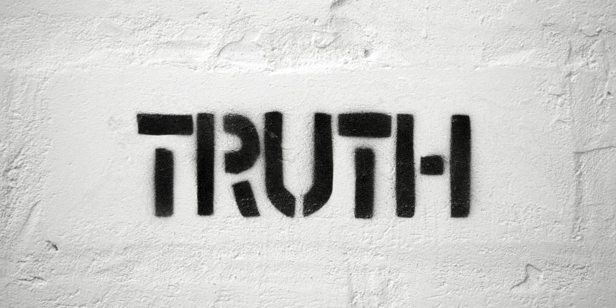 The word Truth stenciled on a white wall
