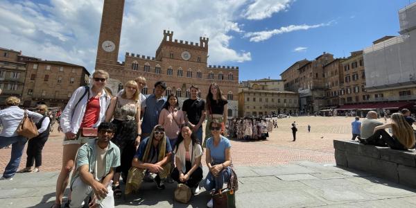 Students stand in a courtyard in Siena