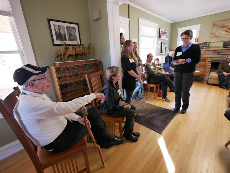 Leland Giovannelli presents a memory book to Clancy and Linda Herbst during a party at the Lesser House.