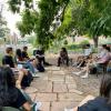 Students on the Lesser House lawn discussing a text