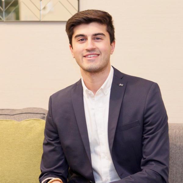 Zuhair Chaudhry sits on a sofa.