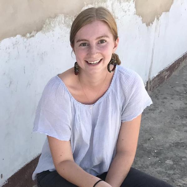 Natalie Furtick sits in front of wall.