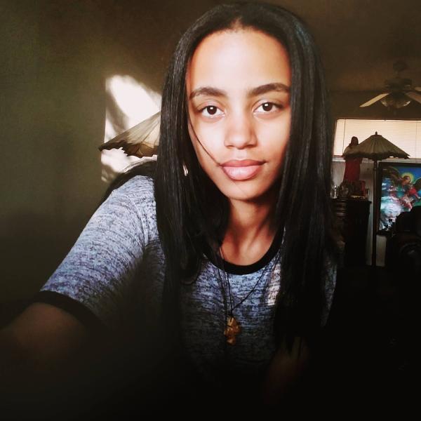 Sunlight shines on Ledya Gebrehiwot's face as the rest is shrouded in shadow