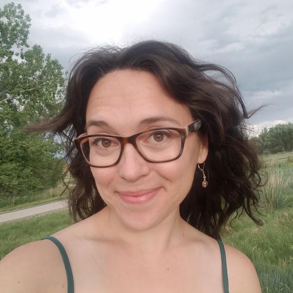 Jessica Ghent stands in front of an open field.