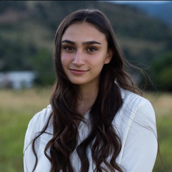 Asma Giornazi stands in front of an open field.