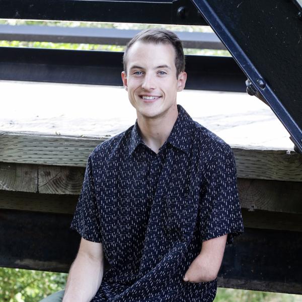 Hank Graham sits on wooden stairs.