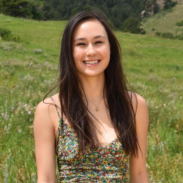 Kiana Harkema stands in front of an open field.