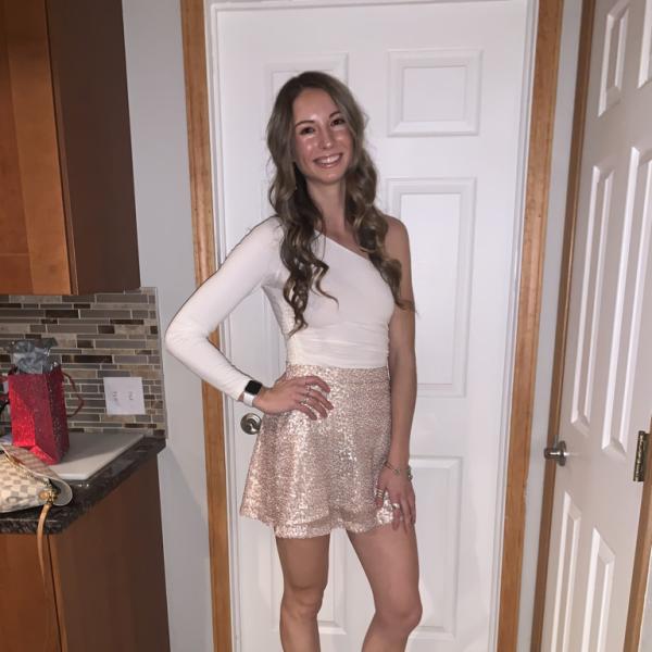Taylor Heisler stands in front of a door.