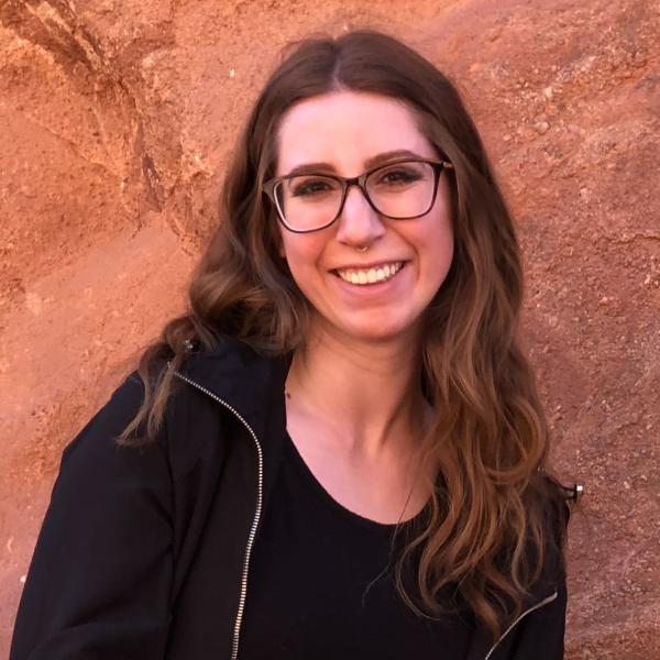 Katelynn Huges standing in front of red rock wall