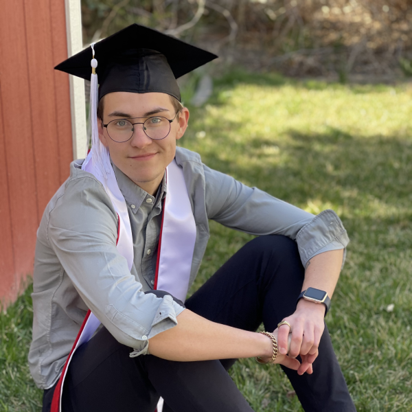 Alex Kramer sits on grass.
