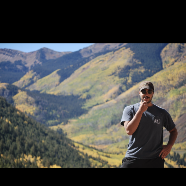Naresh Kumanduri stands on a mountain.