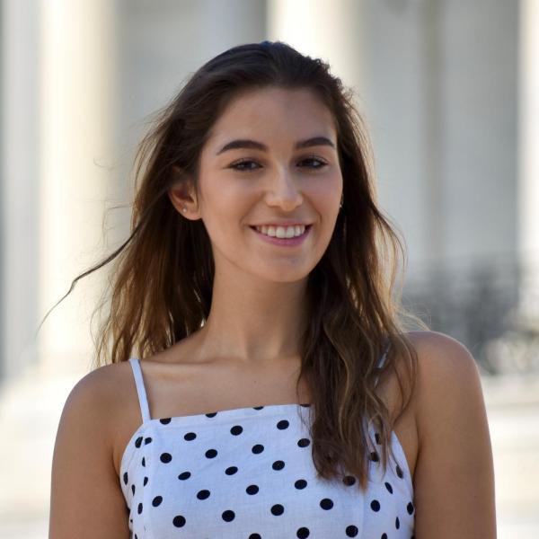 Alexandra Lanzetta stands in front of a building.