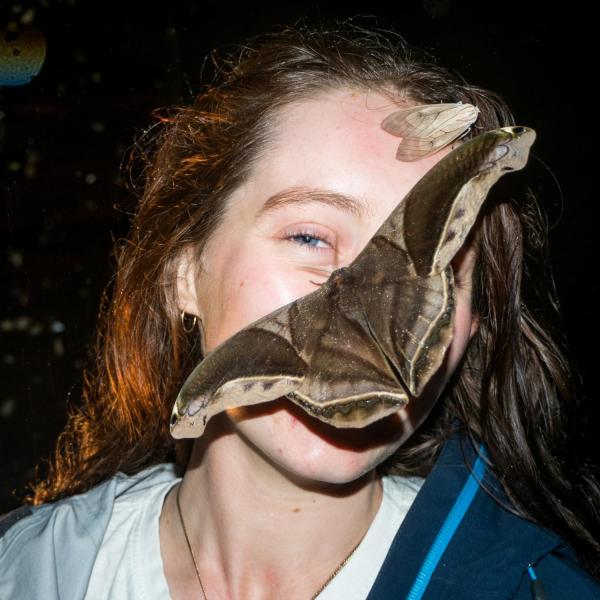 Sydney Lewark pictured with a butterfly on the right side of her face.