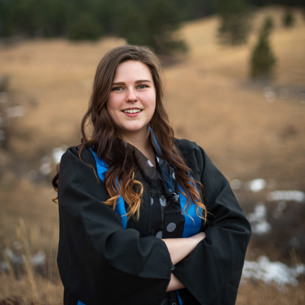Molly MacEachen stands in front of open field.