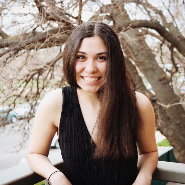 Madison Donnelly on balcony with tree branches in the background