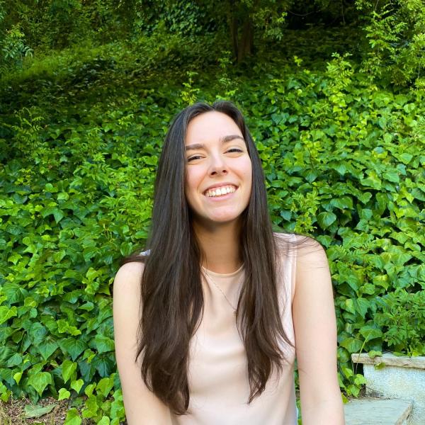 Amy Malacalza sits in front of a tree.