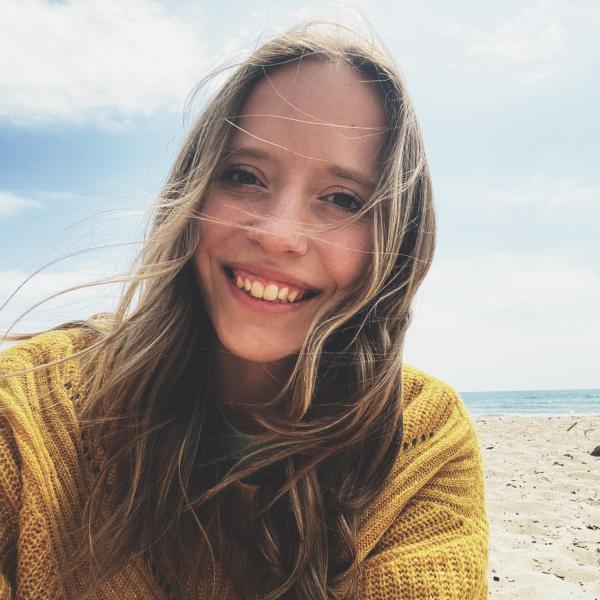 Renae Marshall stands in front of an ocean.