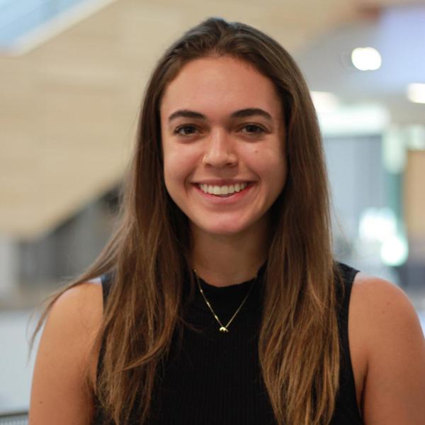 Mikaila Wahl wears a black sleeveless shirt and smiles for the camera