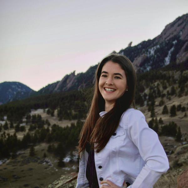 Molly Madden smiles with the Flatirons mountains in the background