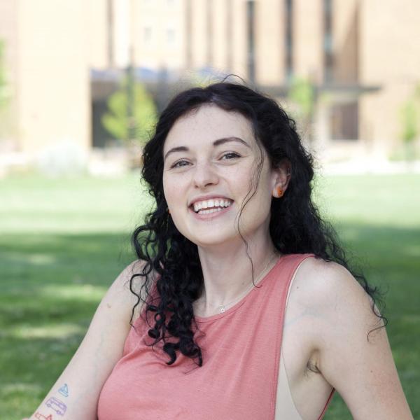 Natania Bloch relaxes on a field of green grass