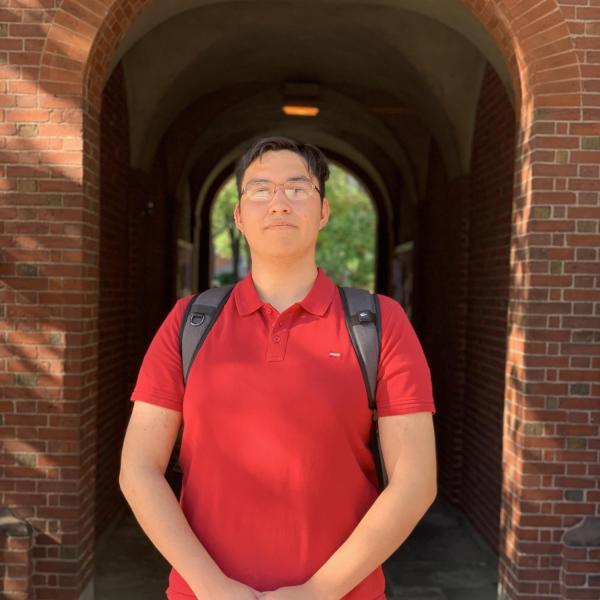Jose Navarro Arriola stands in front of a building.