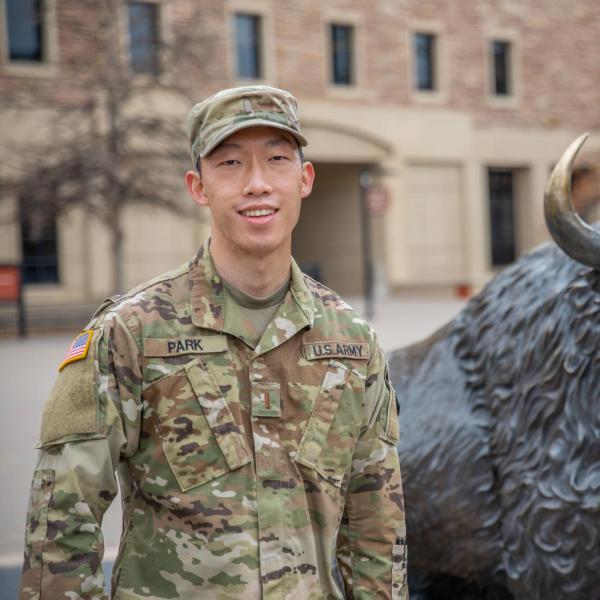 Richard Park stands in front of buffalo statue.